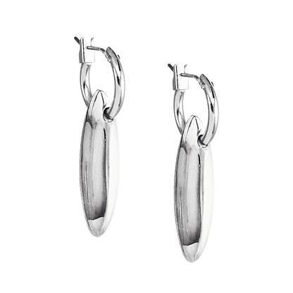udith and Charles x Biko silver mini hoop earrings with hand-cast sculptural charm, polished to perfection, worn on model’s first piercing. Versatile design allows charm to be removed for a sleek solo look. Rhodium plated, hypoallergenic posts. Style BK-W2510, made in Toronto, Canada.